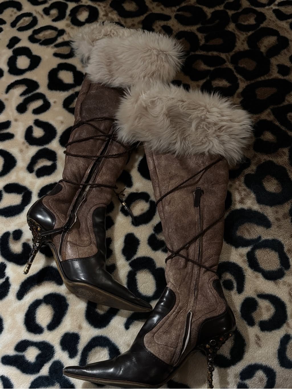 Brown faux-suede over-the-knee boots with black toes and fluffy faux-fur trim.