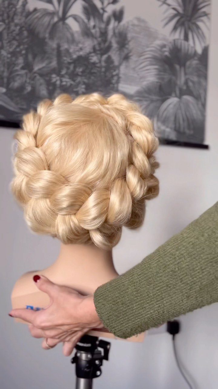 Blonde mannequin head with a thick chunky braided wreath hairstyle wrapped around.