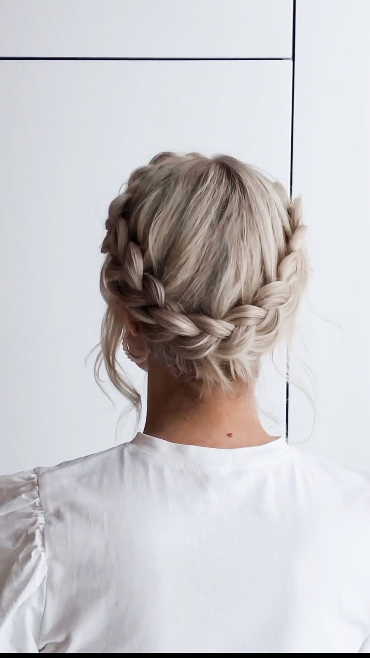 Blonde hair styled in a thick crown braid wrapped around the head.
