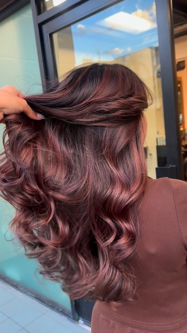 6 Auburn Burgundy Hair Ideas for Every Length and Style 6 Long wavy auburn burgundy hair with balayage highlights shown from the back.