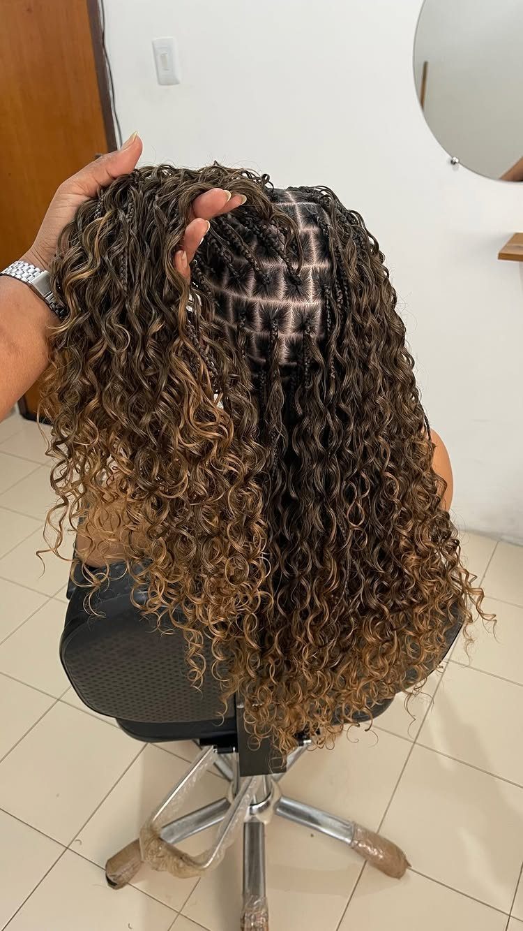 Blonde boho braids with curly ends and square partings on a person.