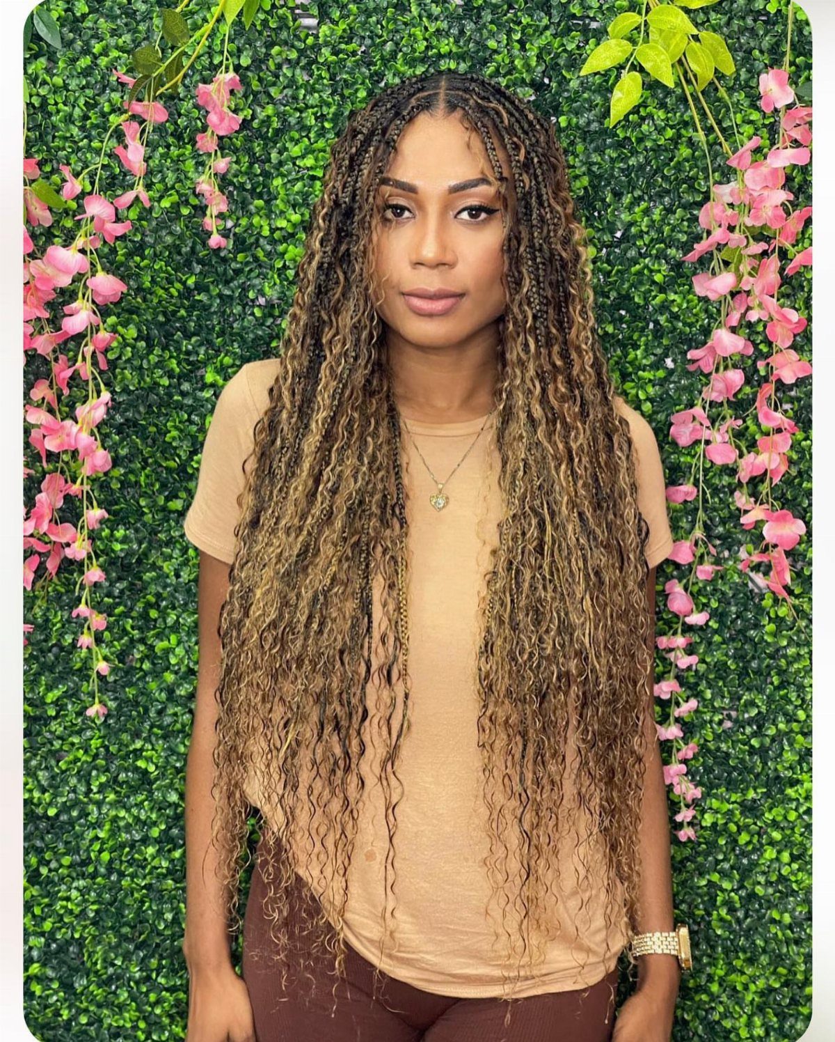 Woman with long ombre boho braids transitioning from dark brown to golden blonde.