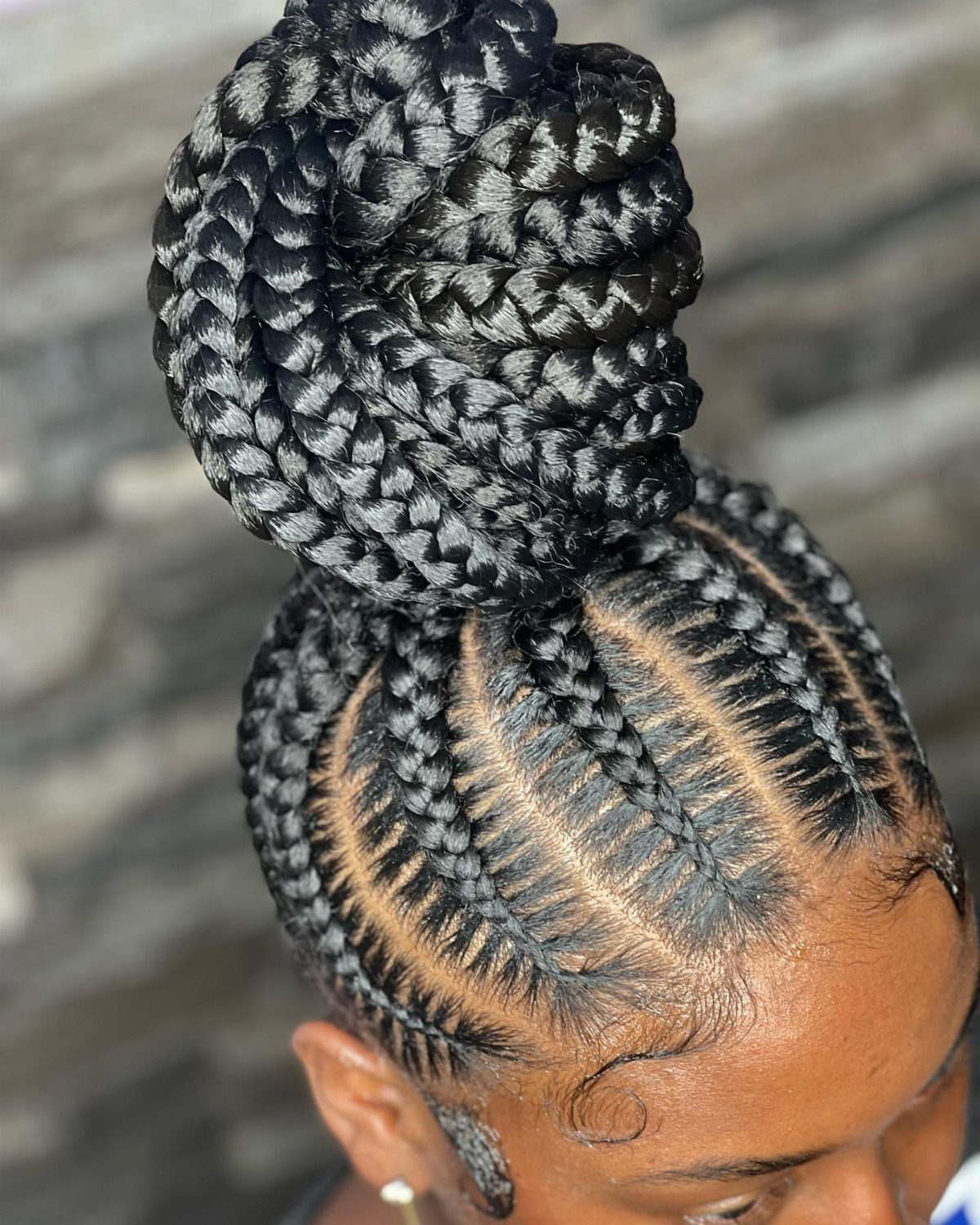 16 Bun Hairstyles for Homecoming: Updos, Braids and More 2 High braided bun with tight cornrows leading into a large coiled top knot.