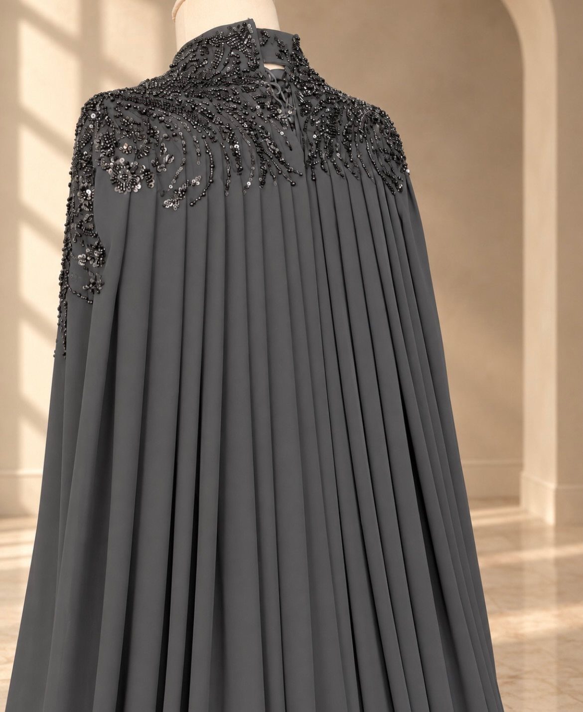Celaena Sardothien Dresses: 10 Gown Ideas from the Books 9 Dark grey pleated gown with black sequin embroidery on the shoulders and neckline.