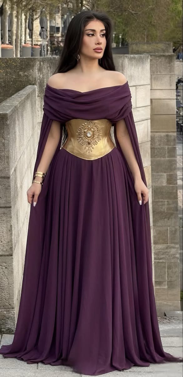 Celaena Sardothien Dresses: 10 Gown Ideas from the Books 6 Woman wearing a floor-length purple off-the-shoulder gown with a gold ornate corset belt.