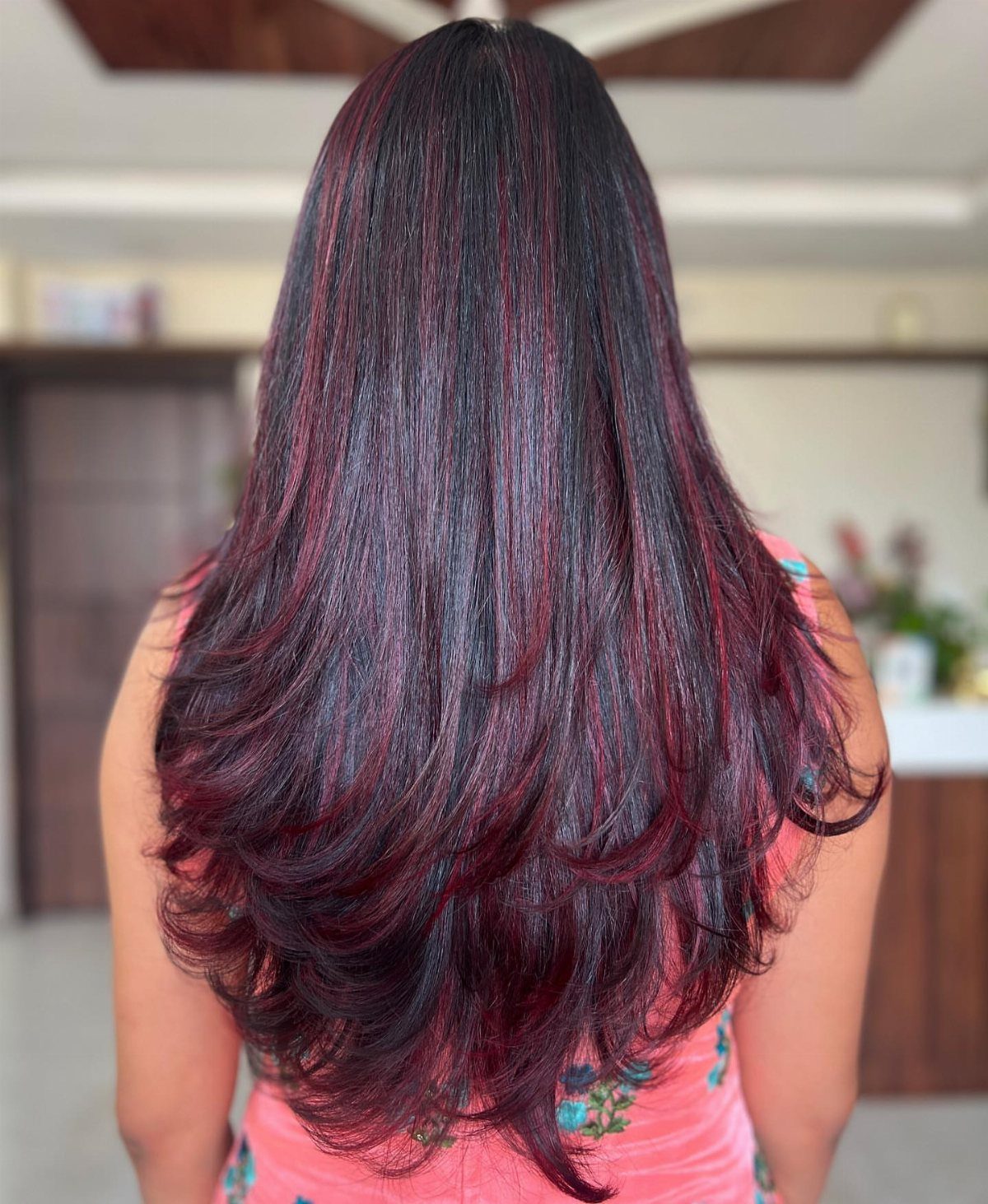 Cherry Red Hair Aesthetic: 7 Ideas for Every Length 5 Long dark hair with vibrant cherry red highlights and layered ends from behind.