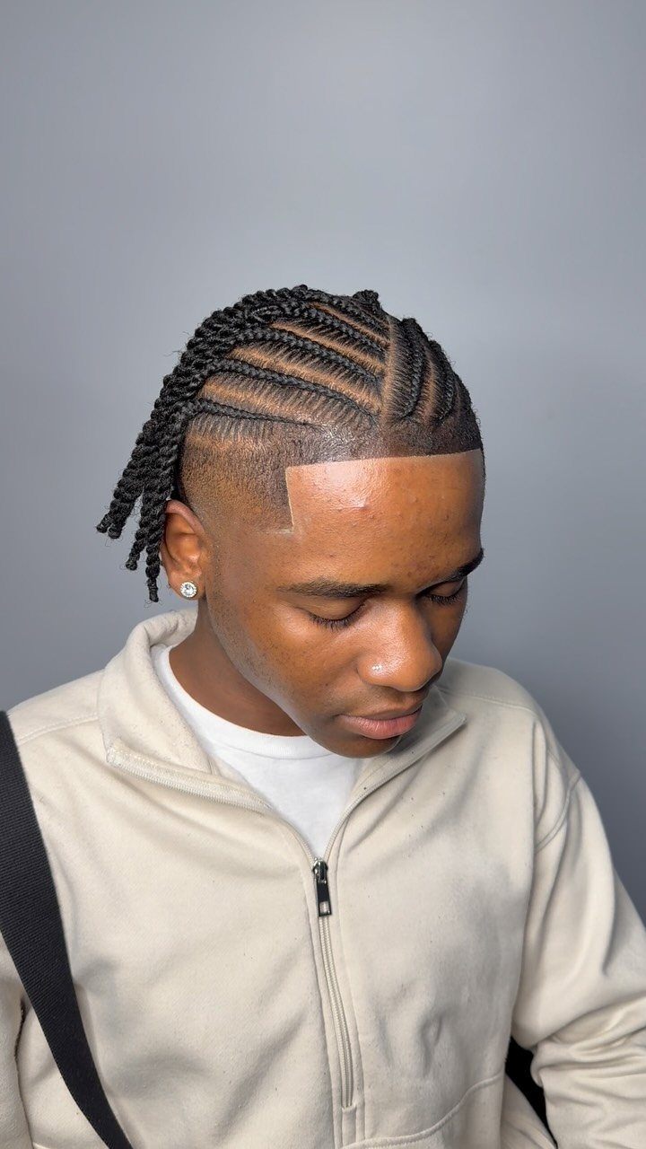 Man with cornrow braids on top and a clean fade on the sides.