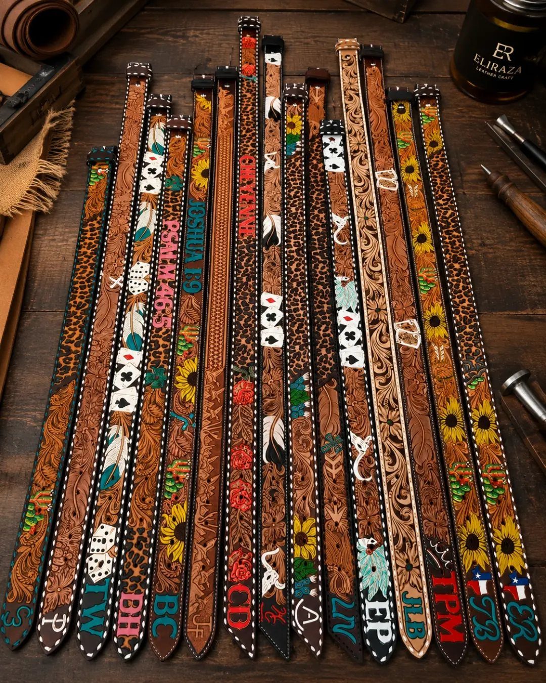 Assorted brown leather Western belts with colorful embroidery and embossing on wooden background