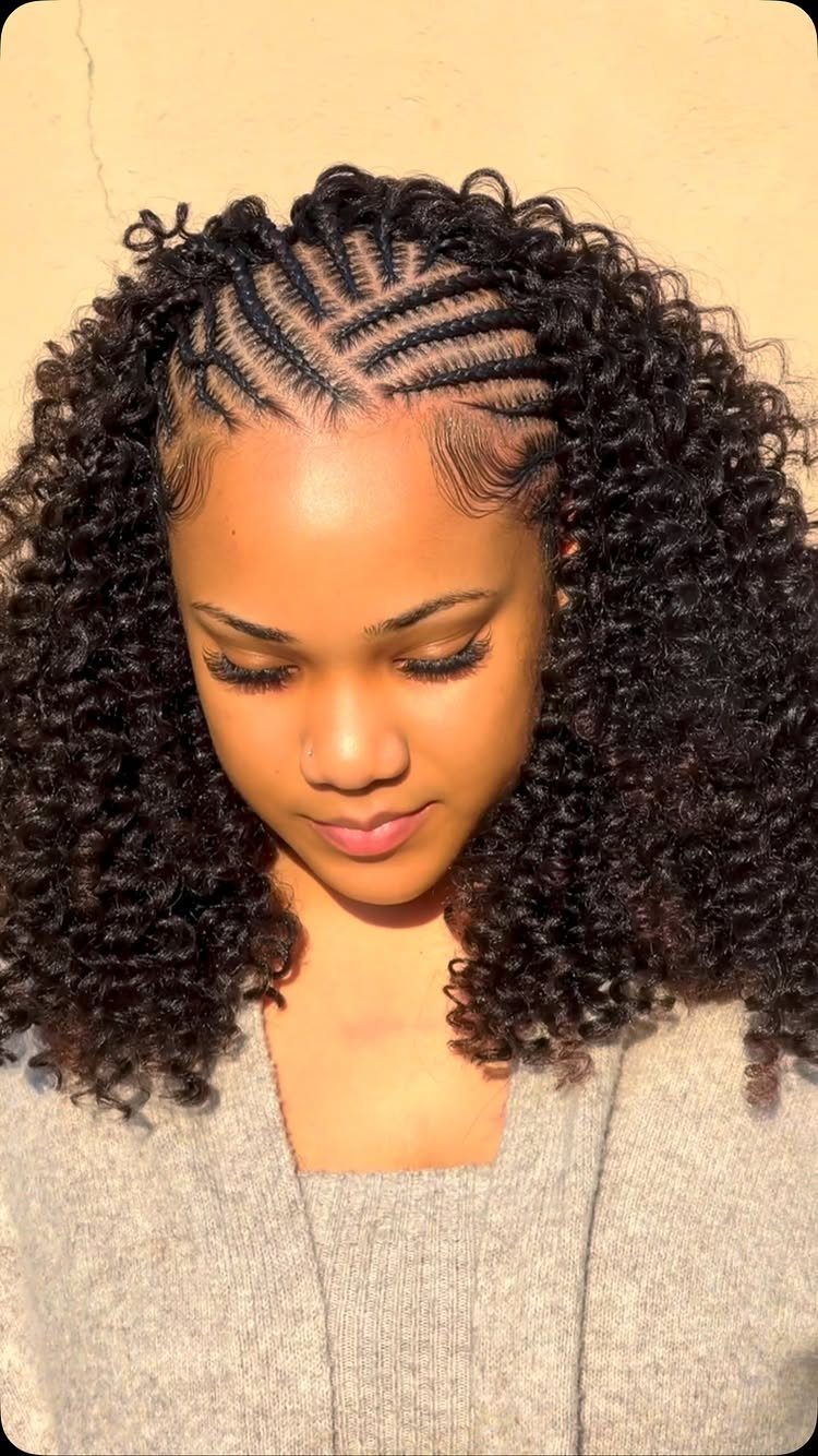 13 Curly Hair Half Up Styles with Braids, Twists and Puffs 10 Woman with curly black hair featuring intricate criss-cross cornrow braids on top.
