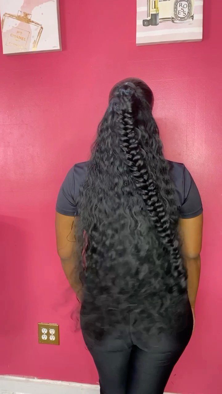 13 Curly Hair Half Up Styles with Braids, Twists and Puffs 7 Long dark curly hair with a central fishtail braid half-up style against pink wall