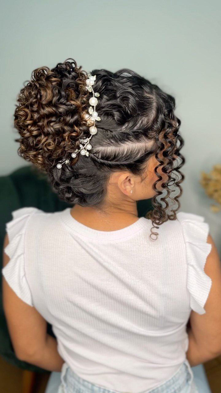 13 Curly Hair Half Up Styles with Braids, Twists and Puffs 4 Woman with curly hair in a pearl adorned topknot and cascading curls.