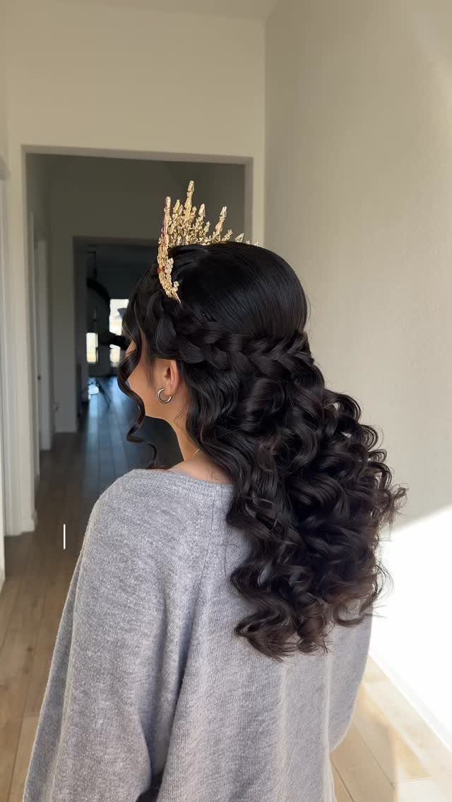 13 Curly Hair Half Up Styles with Braids, Twists and Puffs 3 Woman with dark curly hair in a twisted crown half-updo wearing a gold crown.