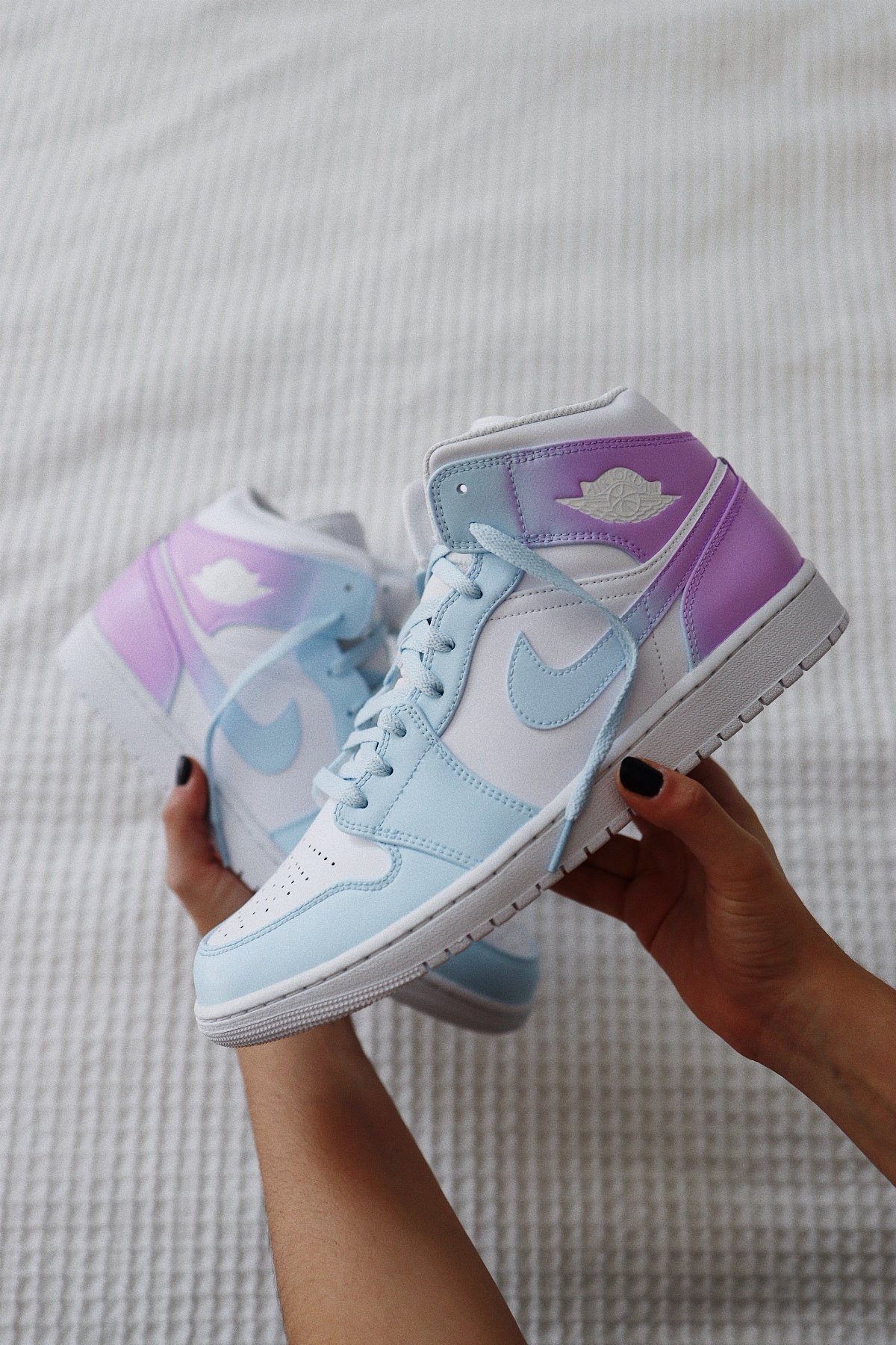 Custom Nike High Tops: 5 Ideas for Your Next Pair 2 Ombre gradient high-top sneakers transitioning from light blue to purple held by hands.