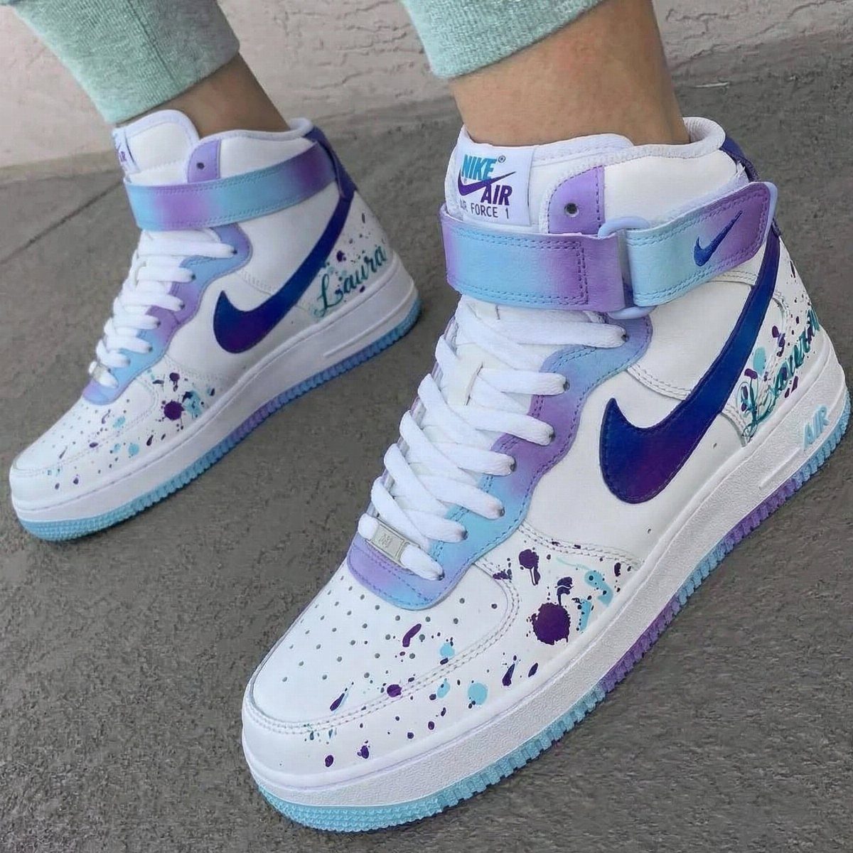 Custom Nike High Tops: 5 Ideas for Your Next Pair 3 White Nike Air Force 1 high tops with purple ombre and blue paint splatters.