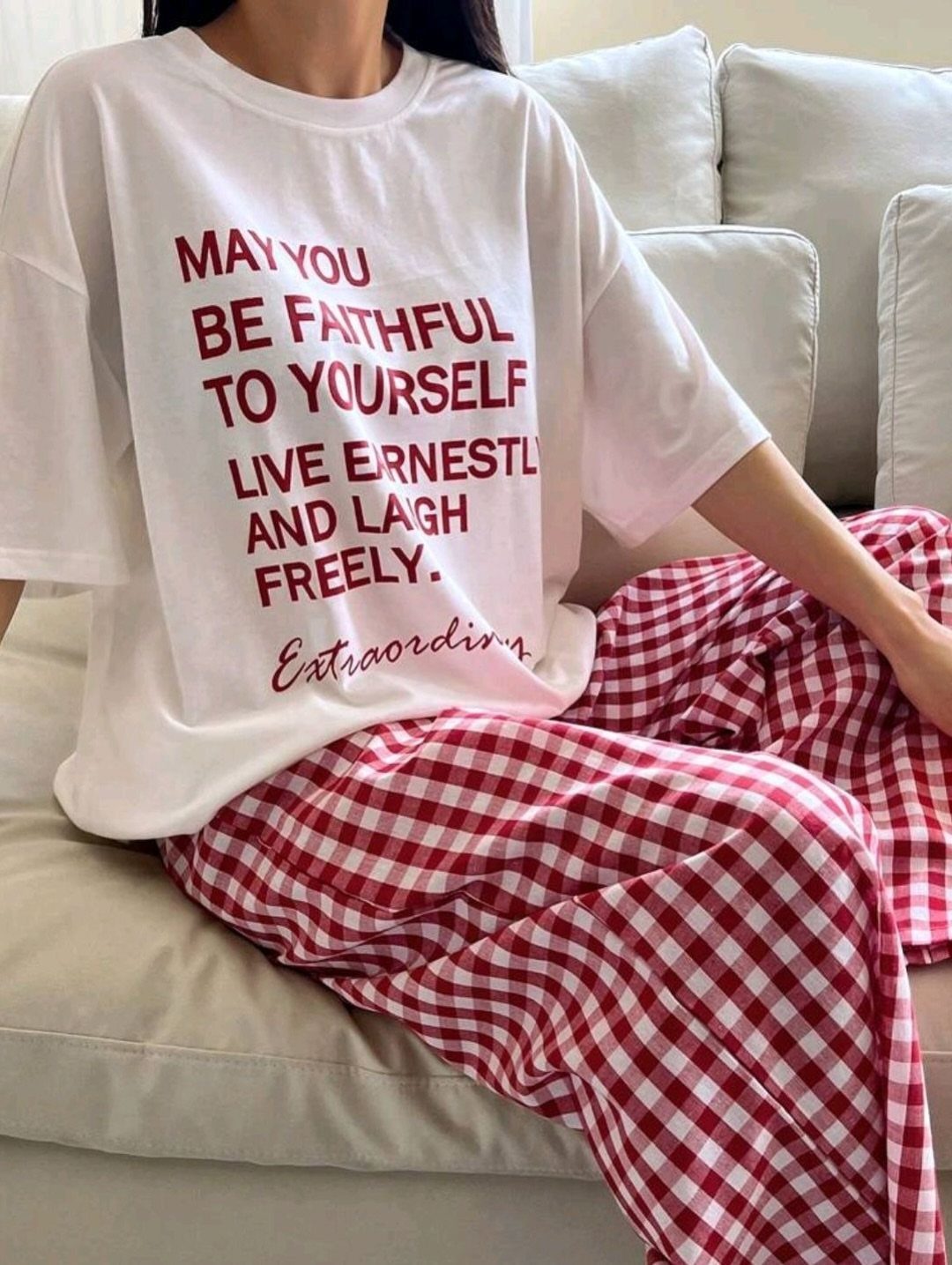 Person wearing red and white gingham wide-leg pajama pants and a white t-shirt.