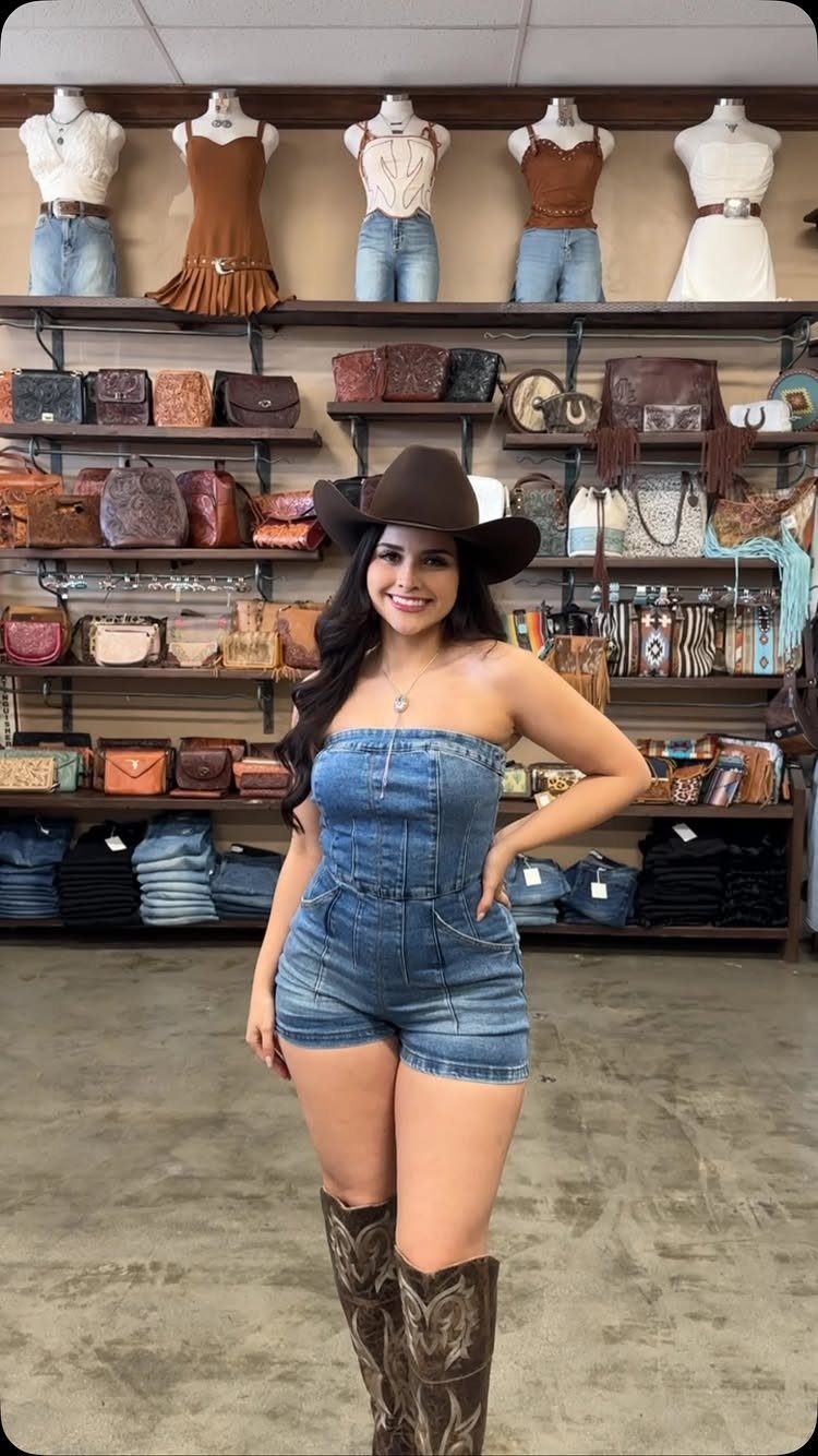 9 Cute Cowboy Outfits with Boots, Denim and Western Flair 1 Woman wearing a denim romper, brown cowboy hat, and patterned cowboy boots.