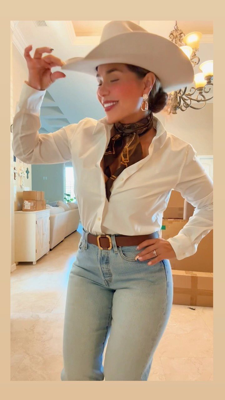 9 Cute Cowboy Outfits with Boots, Denim and Western Flair 8 Woman in white blouse, light blue jeans, and white cowboy hat posing indoors.