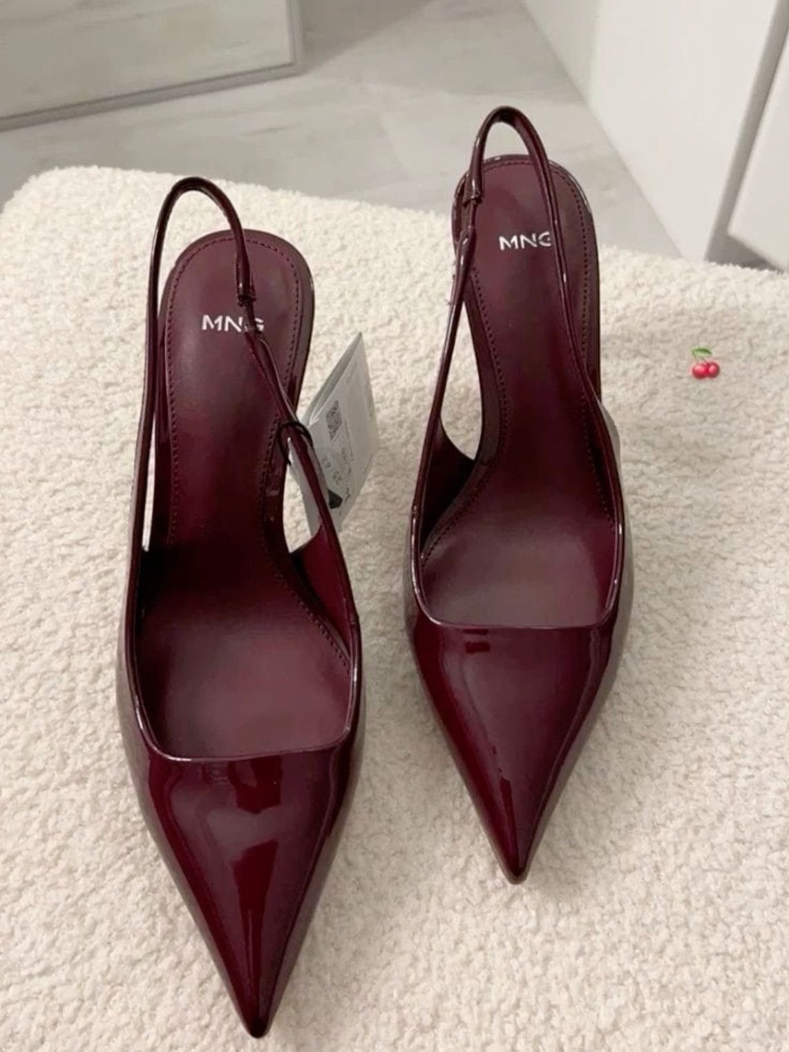 Cute Going Out Shoes to Wear Tonight: 7 Ideas for Women 6 Burgundy patent leather pointed-toe slingback heels resting on a white textured rug.