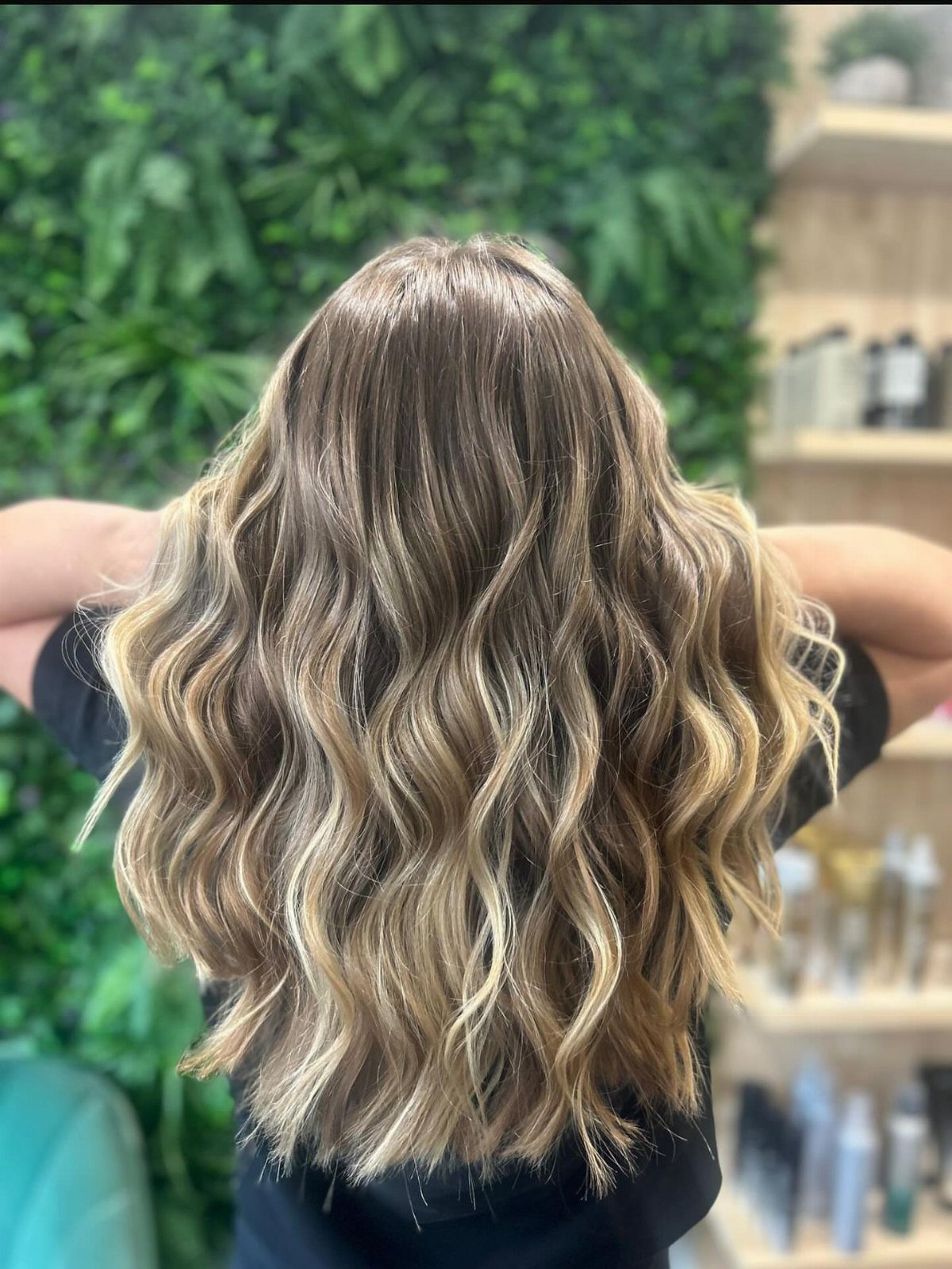 Long blonde and brown hair styled in loose, effortless beach waves from behind.