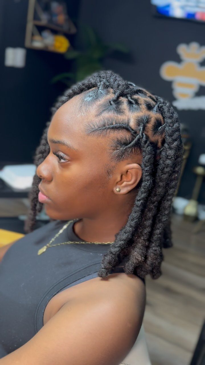 Woman with a braided bob hairstyle featuring scalp braids and thick twisted locks.