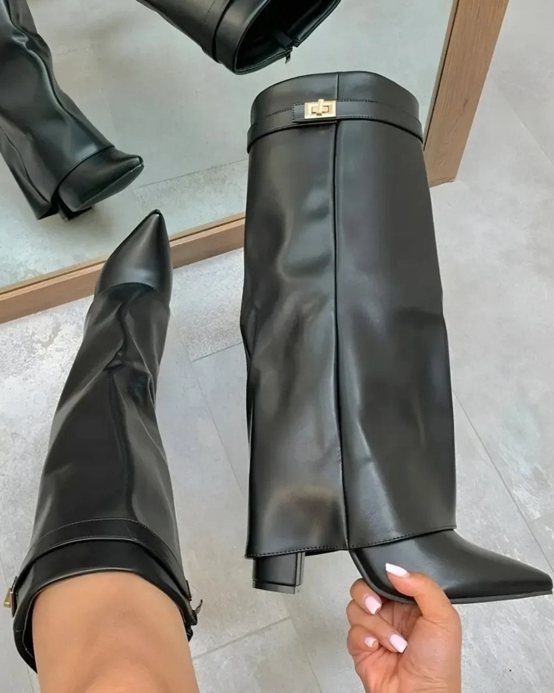 Cute Long Boots: 10 Ideas, From Combat to Over the Knee 1 Black leather knee-high boots with pointed toes and block heels on tiled floor.