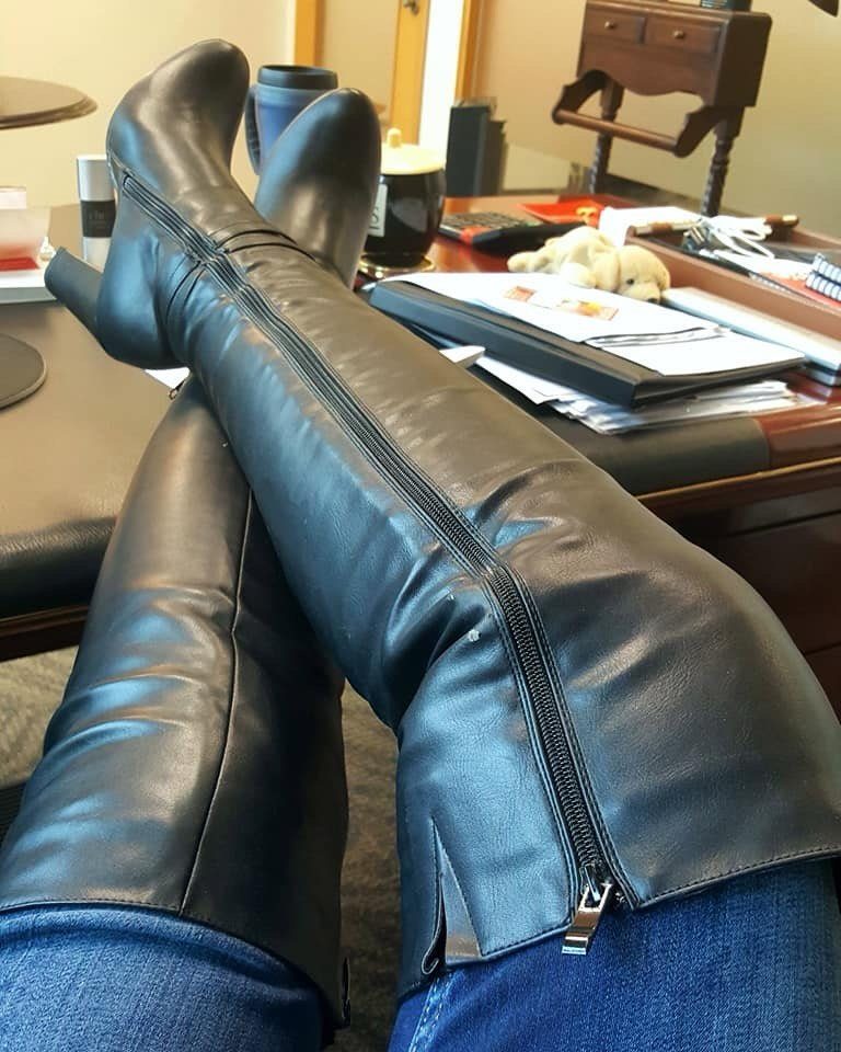 Cute Long Boots: 10 Ideas, From Combat to Over the Knee 6 Black leather over-the-knee boots with zippers worn with blue jeans on a desk.