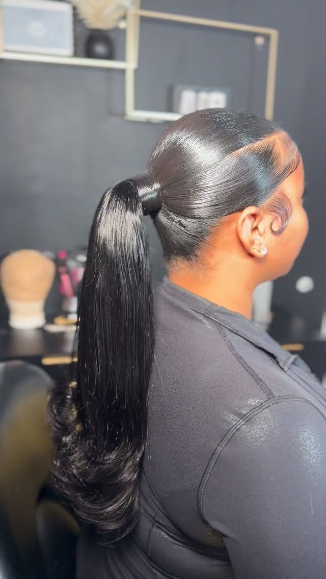 18 Cute Ponytail Hairstyles for Every Mood and Length 9 Woman with a sleek high ponytail and hair-wrapped base in a salon.