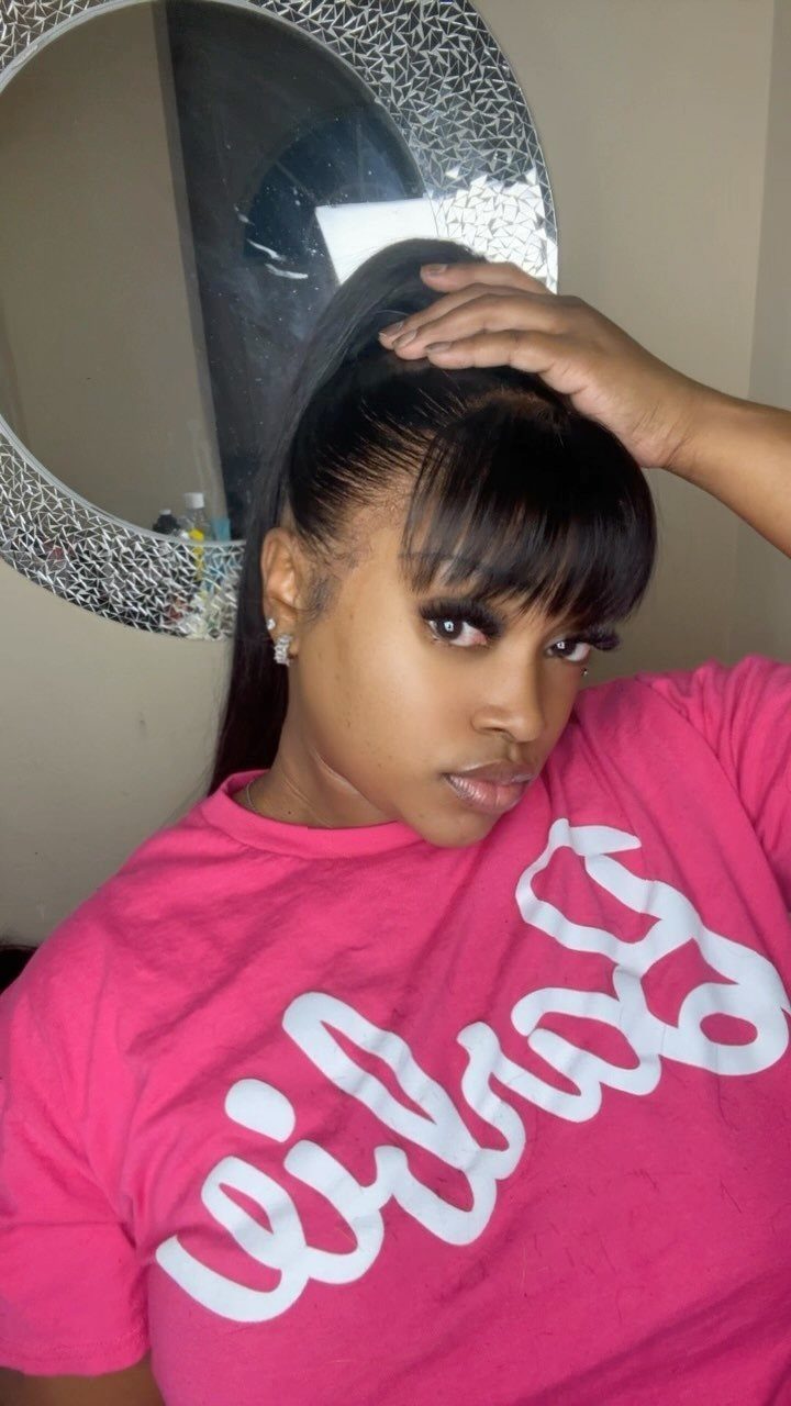 18 Cute Ponytail Hairstyles for Every Mood and Length 8 Woman with a high ponytail and straight bangs wearing a pink t-shirt.