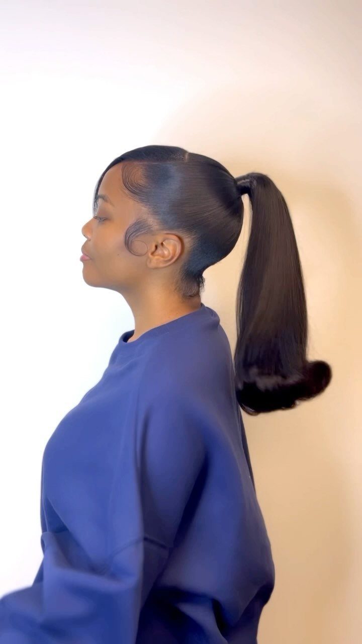 18 Cute Ponytail Hairstyles for Every Mood and Length 2 Woman with a sleek high ponytail and a blue sweatshirt in profile.