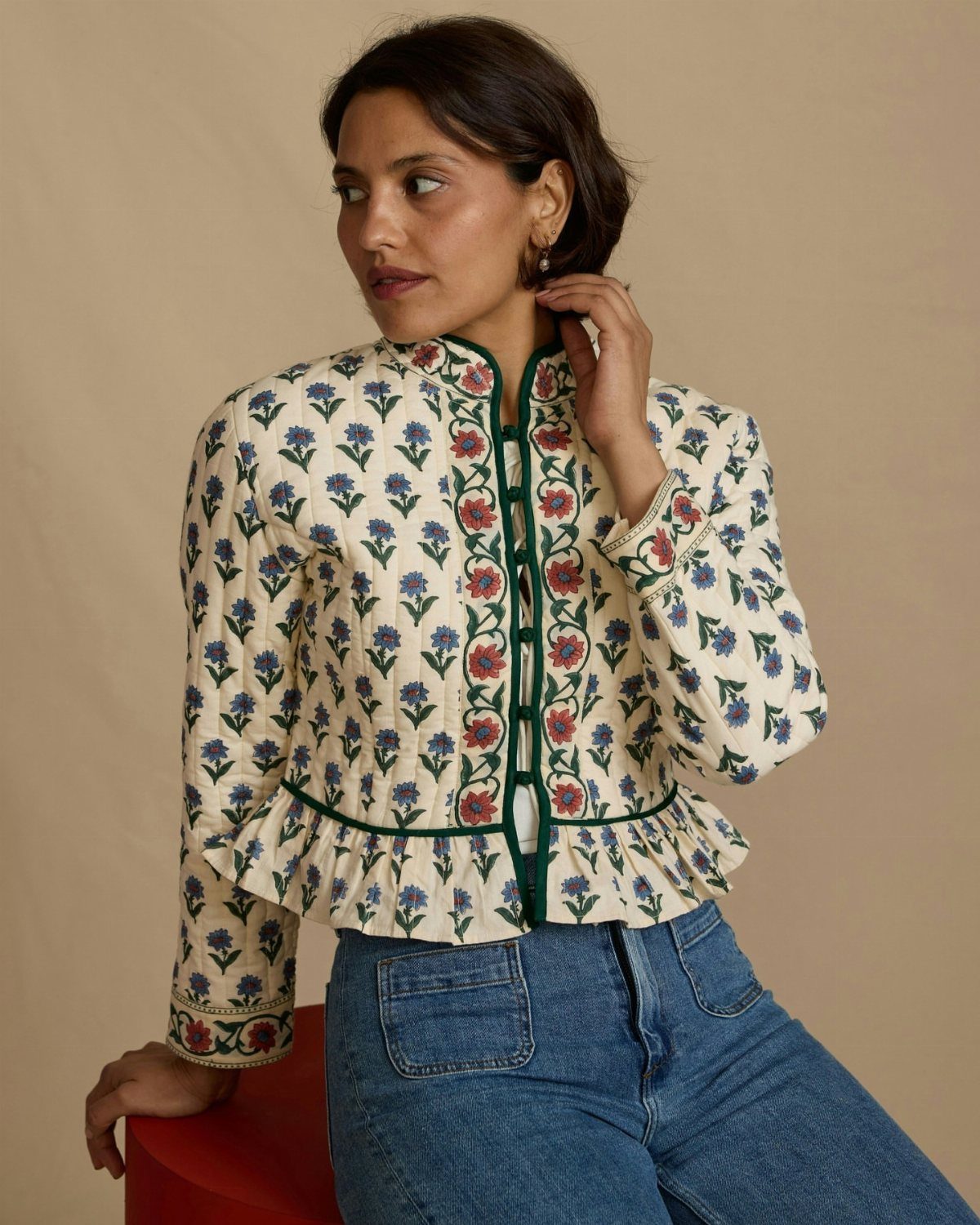 Cute Western Outfits for Women: 13 Ideas to Wear Now 12 Woman wearing a floral quilted jacket with ruffles and blue denim jeans.