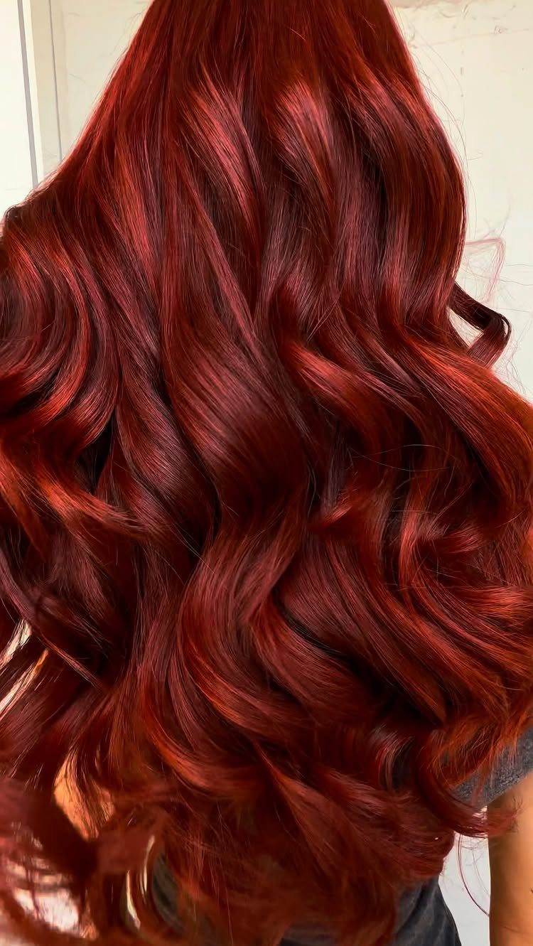 5 Dark Crimson Hair Ideas, From Merlot to Copper Tones 5 Long wavy hair dyed a glossy dark crimson red seen from behind.