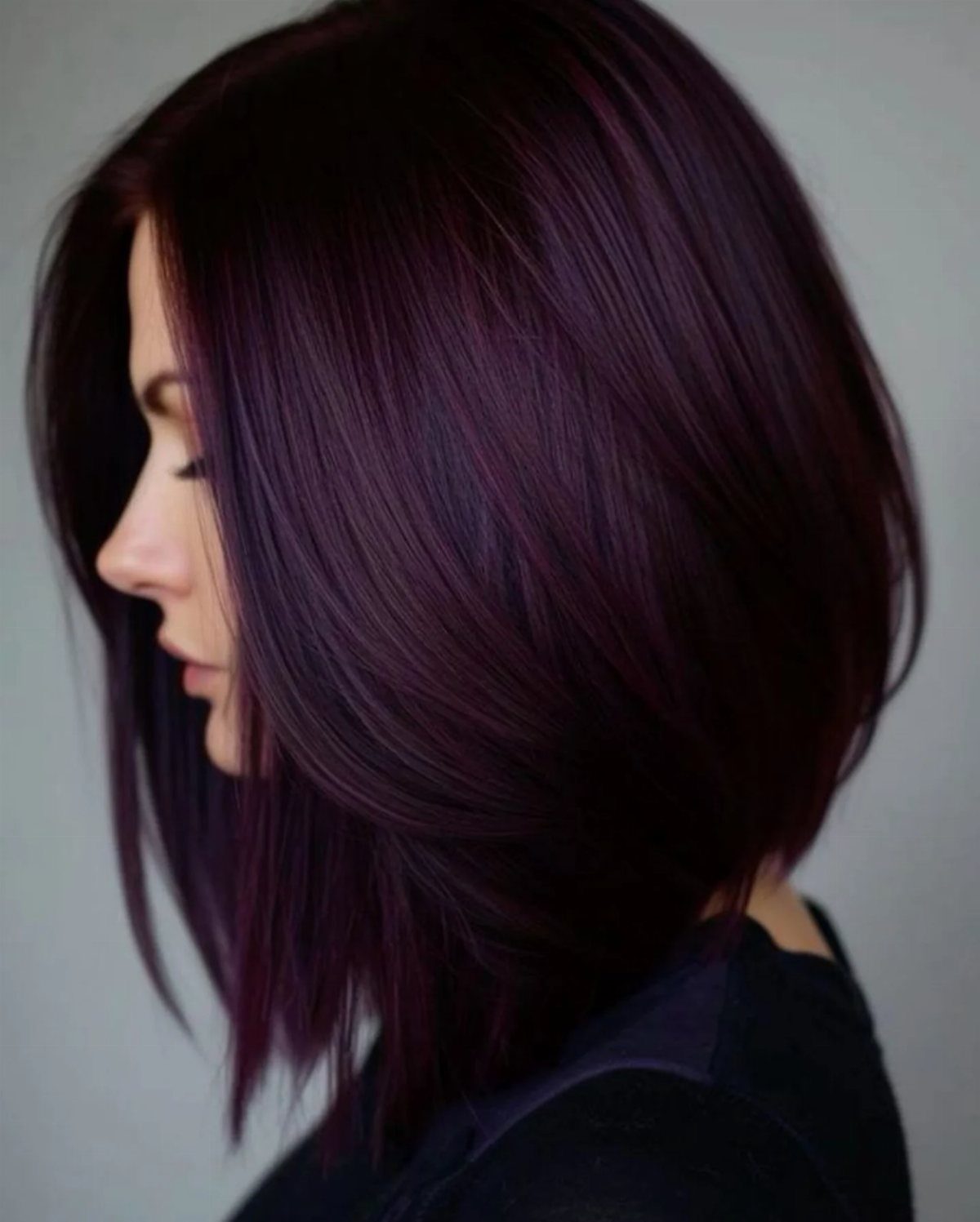 5 Dark Crimson Hair Ideas, From Merlot to Copper Tones 1 Woman with a sleek angled bob in deep merlot wine colored hair.