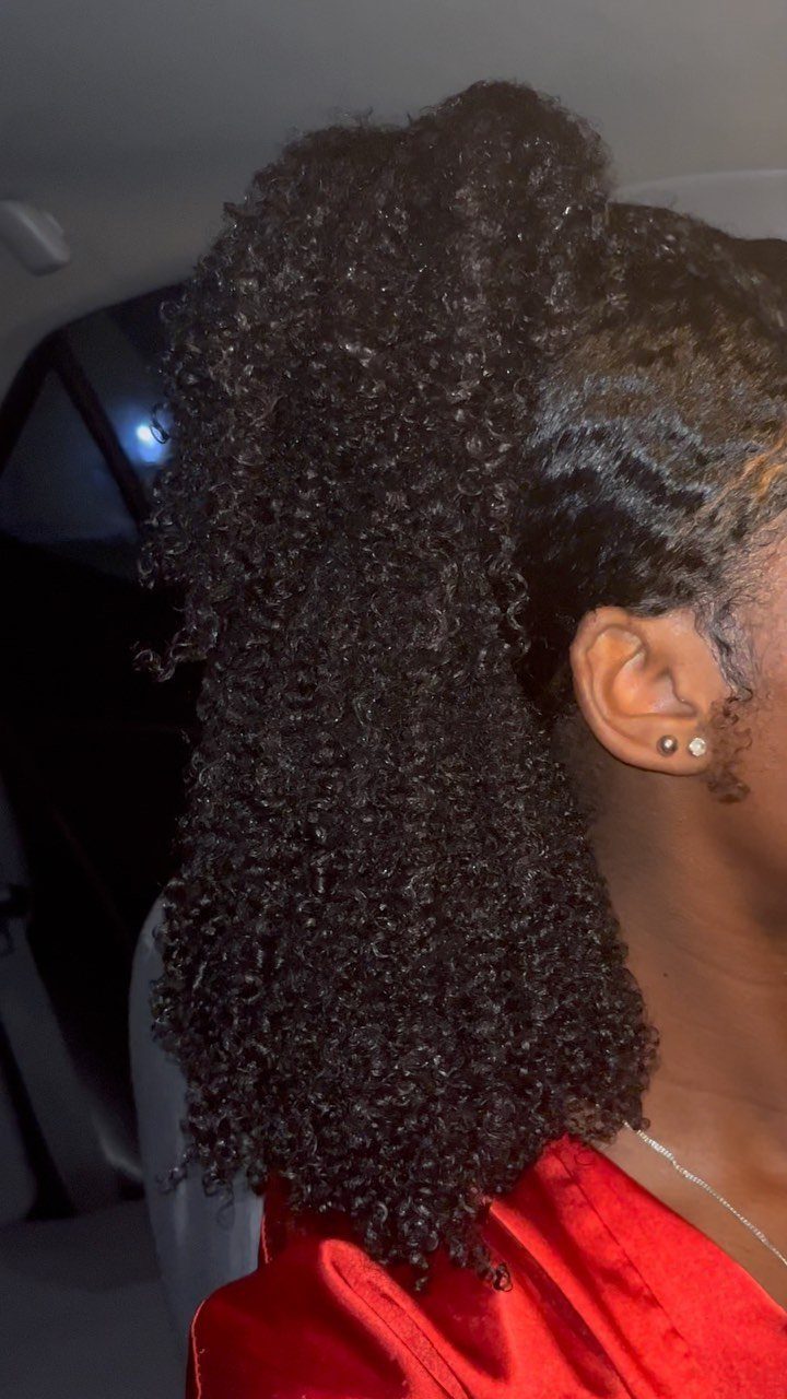 Tightly coiled 4c hair styled in a high, defined ponytail on a person.