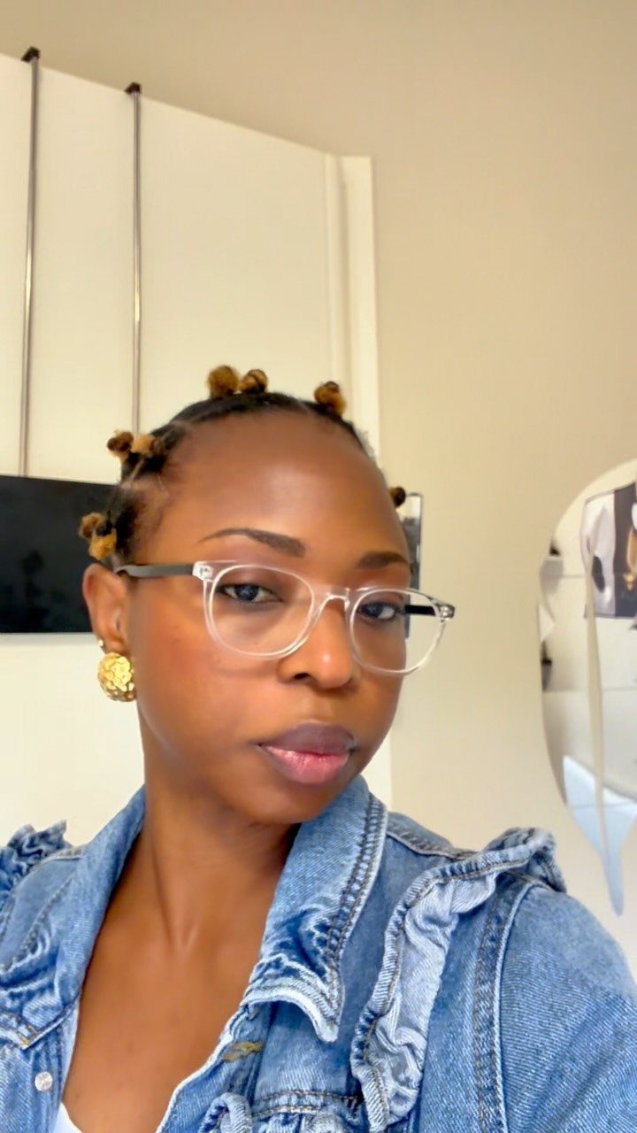 Woman with defined 4c hair styled in small twists with golden-brown tips.