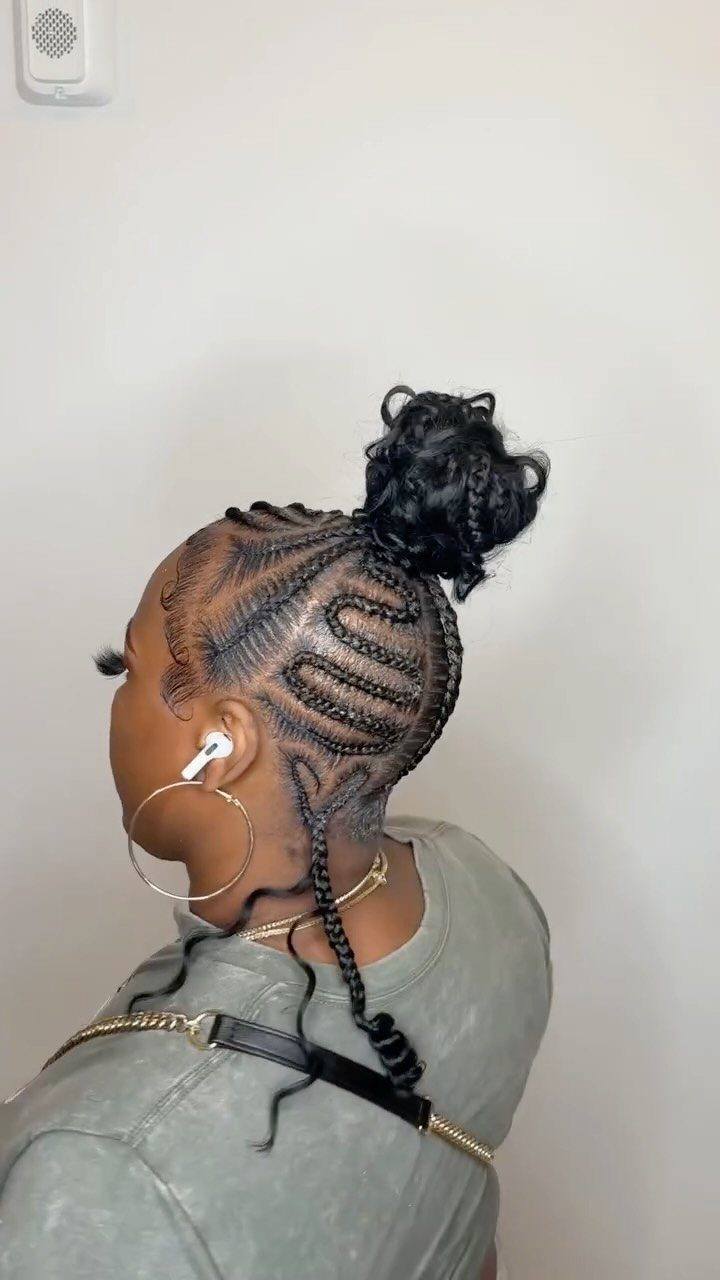 Woman with curved cornrow braids styled into a high braided bun updo.
