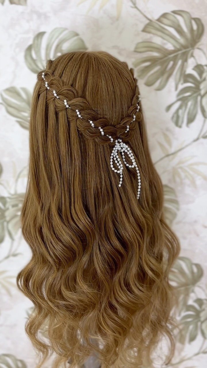 Wavy light brown hair with a horizontal braid and white pearl decorations.
