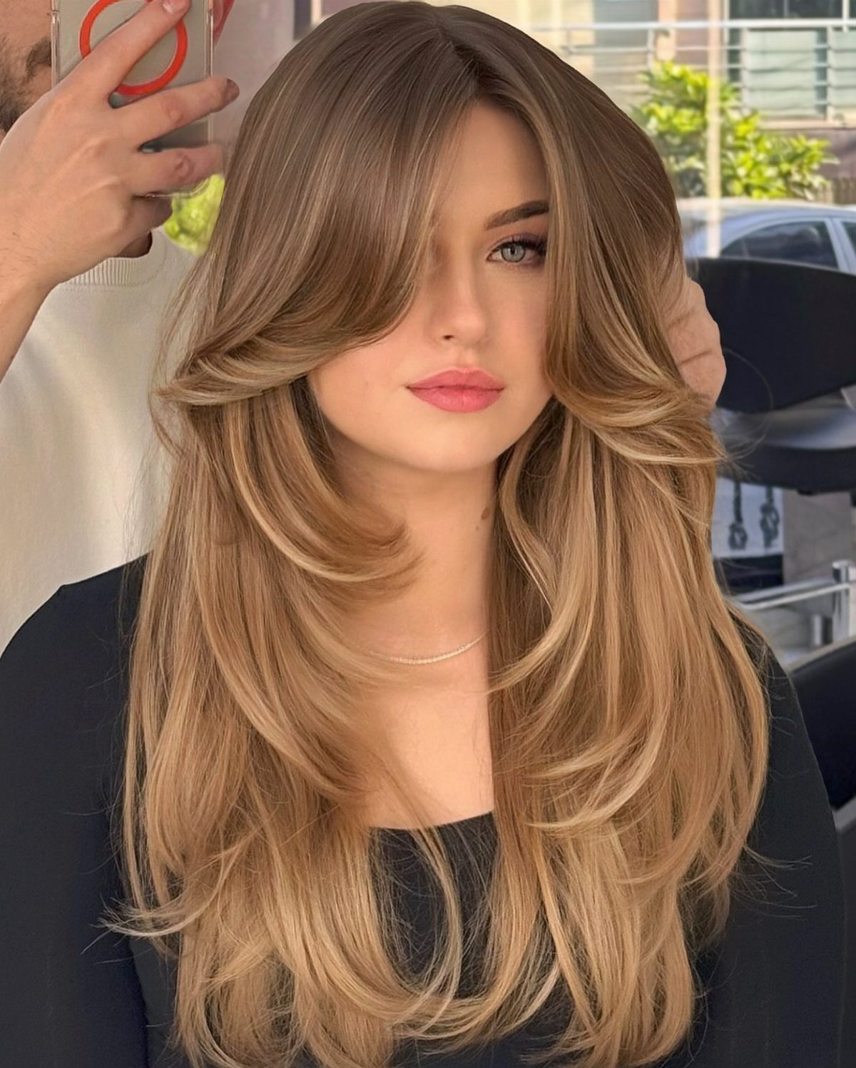 14 Different Color Hair Ideas for Every Skin Tone 11 Woman with long layered golden blonde hair and honey highlights posing indoors.