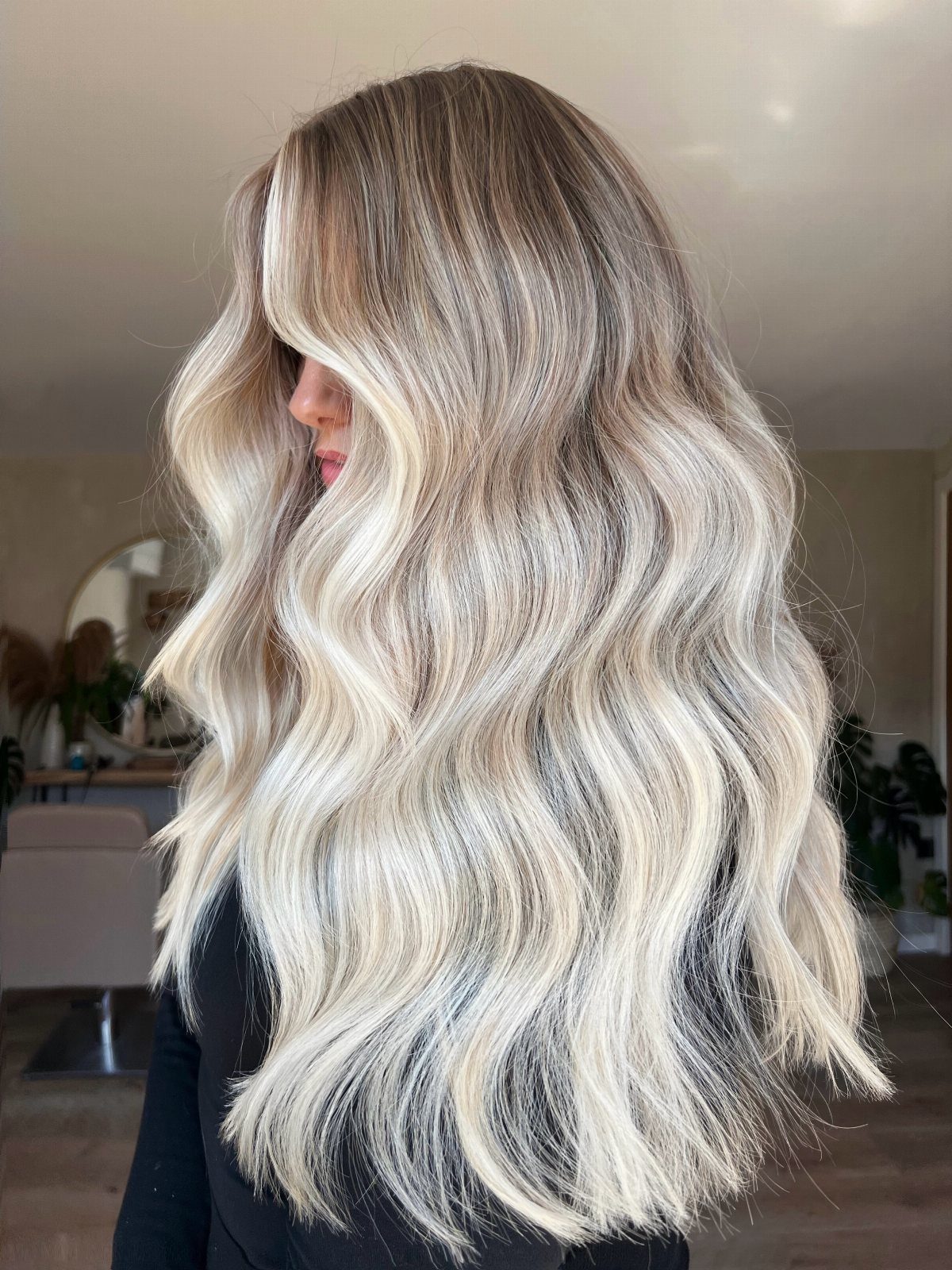 14 Different Color Hair Ideas for Every Skin Tone 13 Long wavy blonde hair with ash tones and bright highlights on a woman.