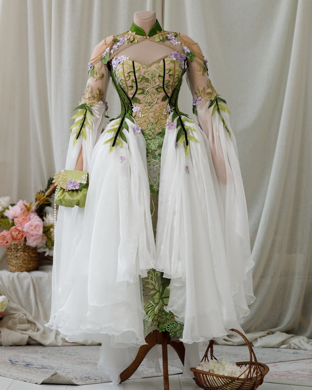 White and green fairy wedding dress with leaf embroidery on a mannequin