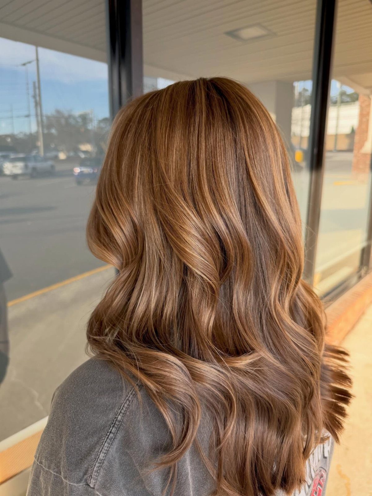 Fall Hairstyles and Color: 16 Ideas, Caramel to Espresso 1 Long wavy brown hair with warm caramel highlights seen from the back.