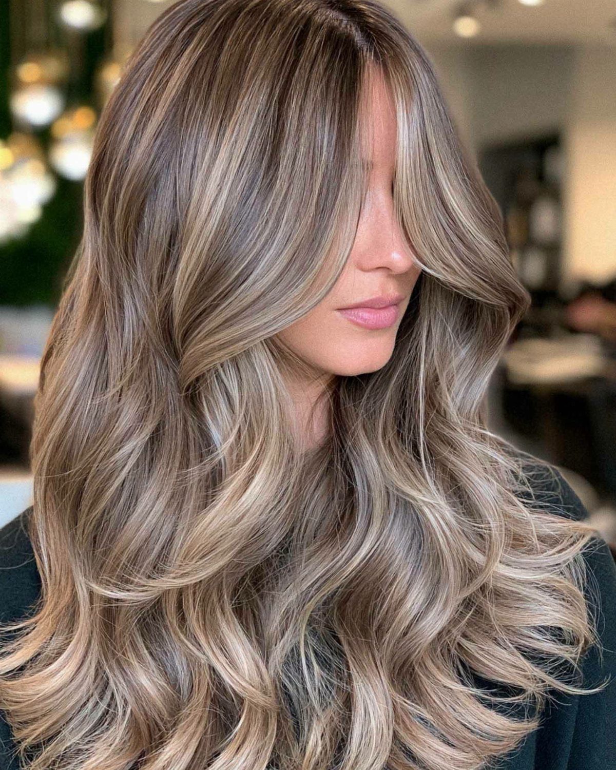 Fall Hairstyles and Color: 16 Ideas, Caramel to Espresso 15 Woman with long wavy champagne blonde hair with beige and ash highlights.