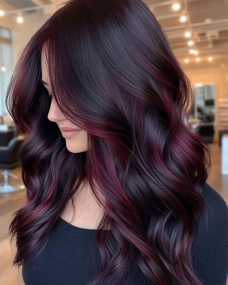 Fall Hairstyles and Color: 16 Ideas, Caramel to Espresso 10 Woman with long wavy hair in deep burgundy and berry-black tones.
