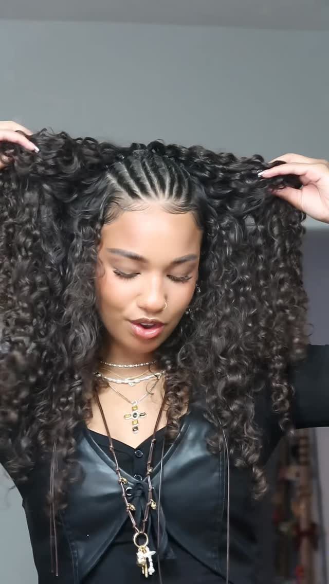 Woman with long curly hair and flat twists on top of her head.