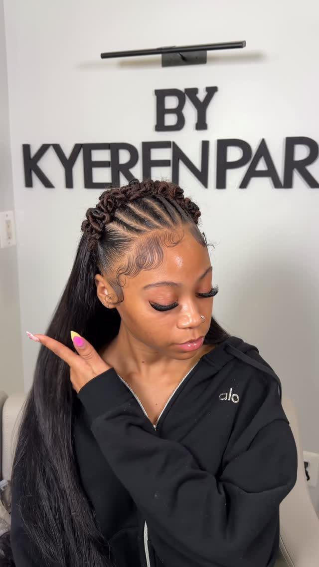 Woman with flat twist braids on top of her long black hair.