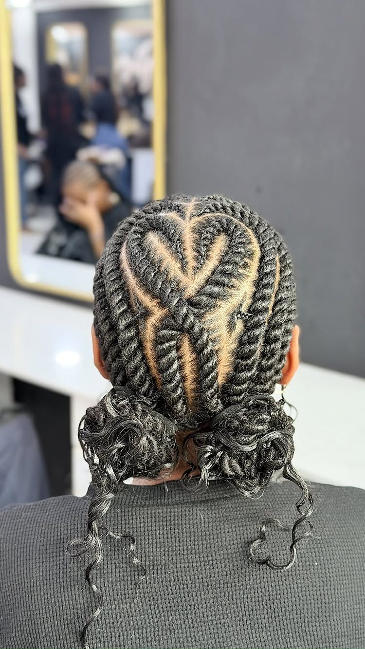 Black hair styled in flat twists forming a heart shape with curly buns.