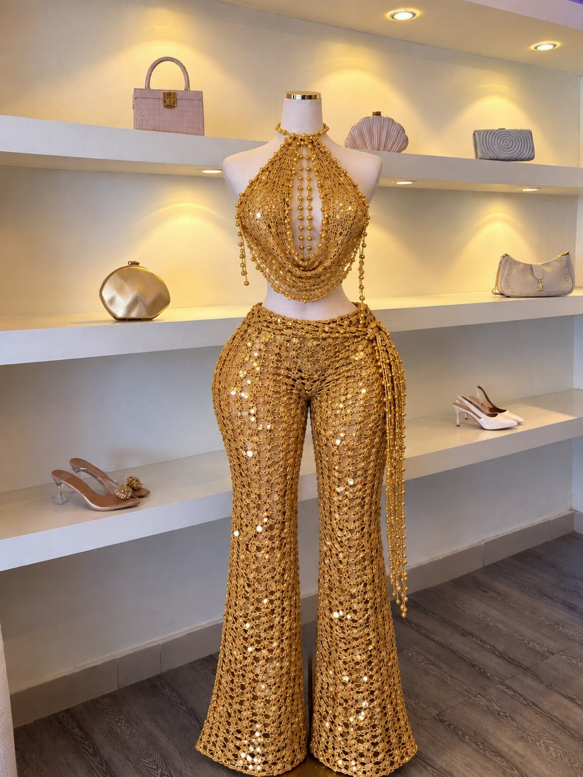 Gold sequined matching set with crop top and wide-leg pants on a mannequin.