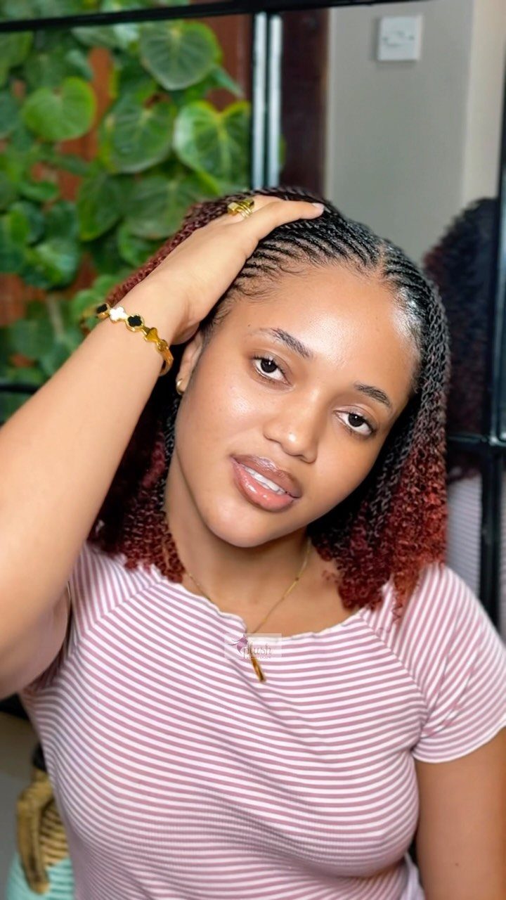 Woman with ultra-thin micro braids transitioning from dark to reddish-brown ends.