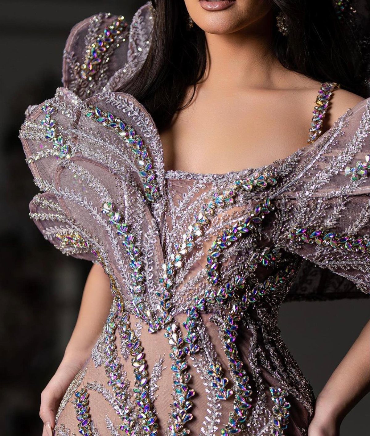 Intricate lavender designer dress with iridescent beadwork and structured crystal shoulder details.