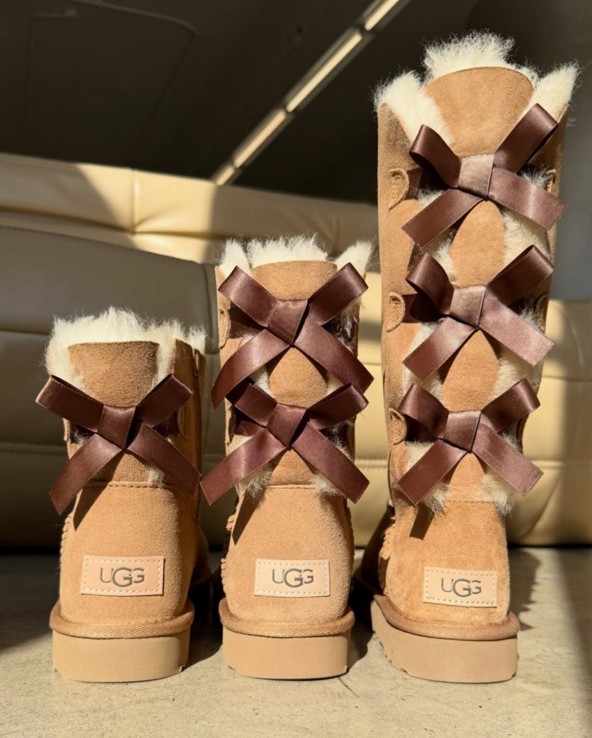 High UGG Boots: 6 Tall Styles From Classic to Adirondack 2 Three tan suede UGG boots of different heights with brown ribbon bow accents.