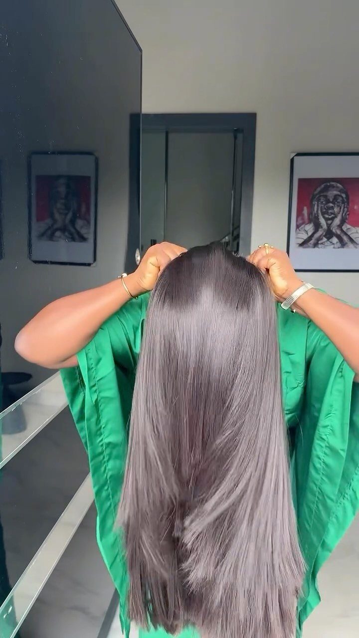 9 Long African Hair Ideas for Braids, Curls and Waves 7 Long straight dark brown hair on a person wearing a green garment.